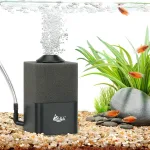 A black silent submersible sponge filter works in an aquarium, bubbling out bubbles.