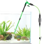 Siphon gravel vacuum working in a fish tank with sand.