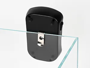 A black aquairum air pump hang on the tank.