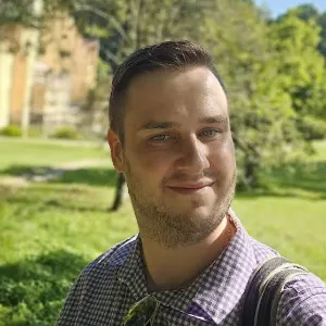 a man smiling on the ground.