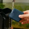 A man is cleaning sponge from aquarium filter.